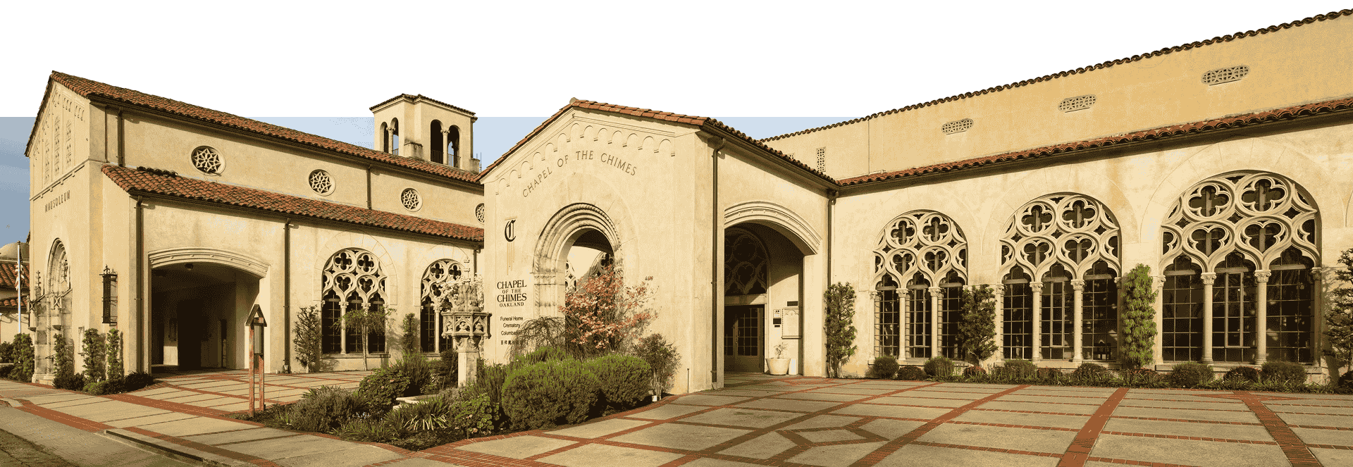 Exterior view of the Chapel of the Chimes Oakland with arched windows and stone facade.