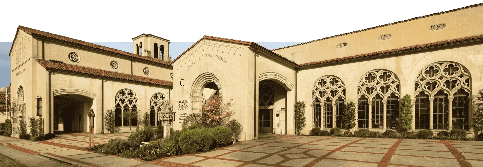 Exterior view of the Chapel of the Chimes Oakland with arched windows and stone facade.
