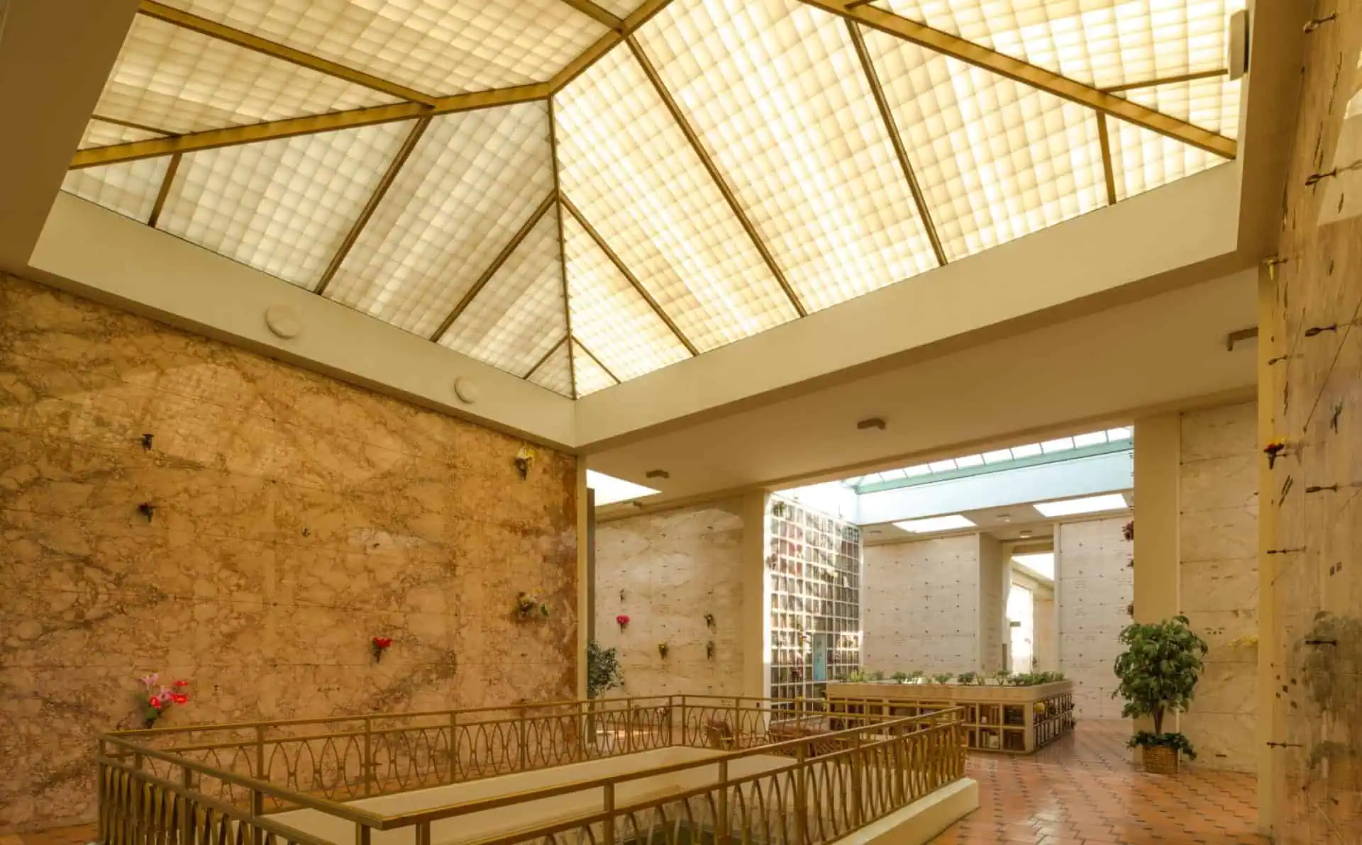 Interior view of a chapel with a glass ceiling and wooden accents.