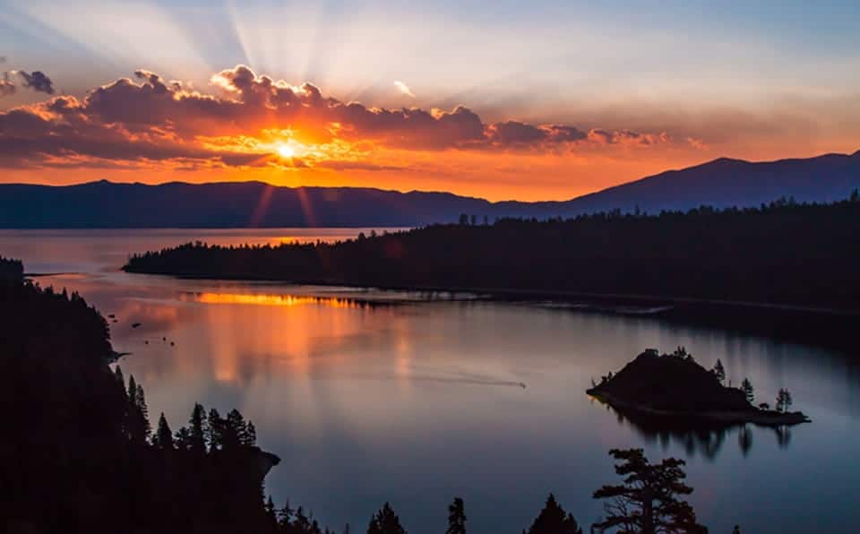 Scenic view of Lake Tahoe at sunset with mountains and sky.