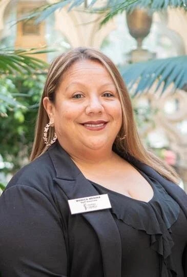 Smiling woman staff member in professional attire at Chapel of the Chimes Oakland.